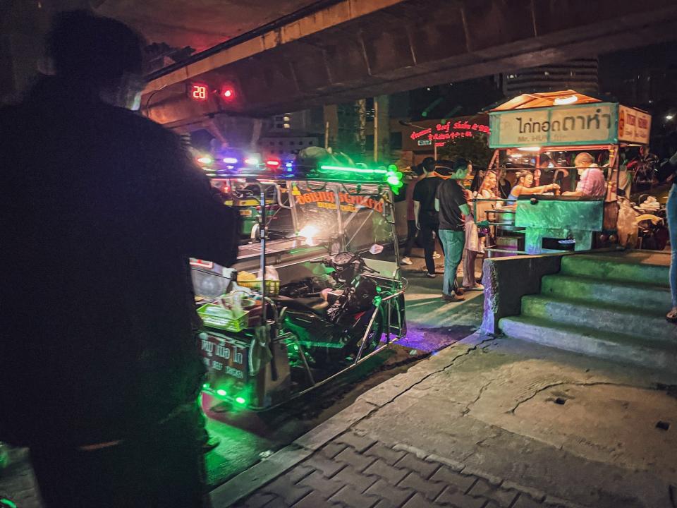 Tuk-tuks and street food stalls just outside the club.