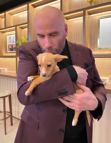 <p>John Travolta/Instagram</p> John Travolta and Peanut at the 2022 Oscars.