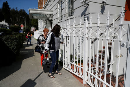 Unidentified women enter a gate at the side entrance to the building of the Consulate General of Russia in San Francisco, California, U.S., August 31, 2017. REUTERS/Stephen Lam