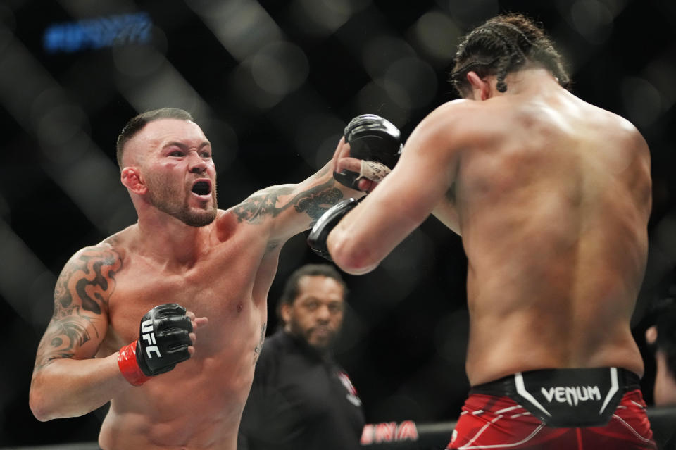 Mar 5, 2022; Las Vegas, Nevada, UNITED STATES; Colby Covington (red gloves) fights Jorge Masvidal (blue gloves) during UFC 272 at T-Mobile Arena. Mandatory Credit: Stephen R. Sylvanie-USA TODAY Sports