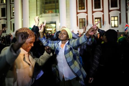 Supporters of South African president Jacob Zuma celebrate after the motion of no confidence against him in parliament was defeated in Cape Town, South Africa, August 8, 2017. REUTERS/Sumaya Hisham