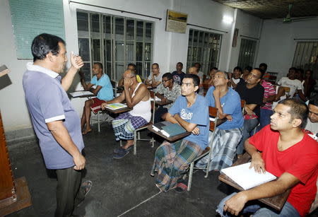 A councillor (L) talks to drug addicts in a classroom at the Bangladesh Rehabilitation and Assistance Centre for Addicts (BARACA) in Dhaka September 12, 2015. REUTERS/Ashikur Rahman