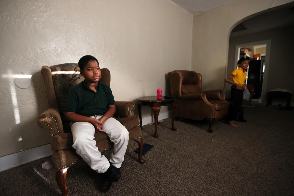 Kevin Bardwell Jr. sits in a living room chair as he waits for the morning school bus from the family's Frayser home on Friday, May 27, 2022.