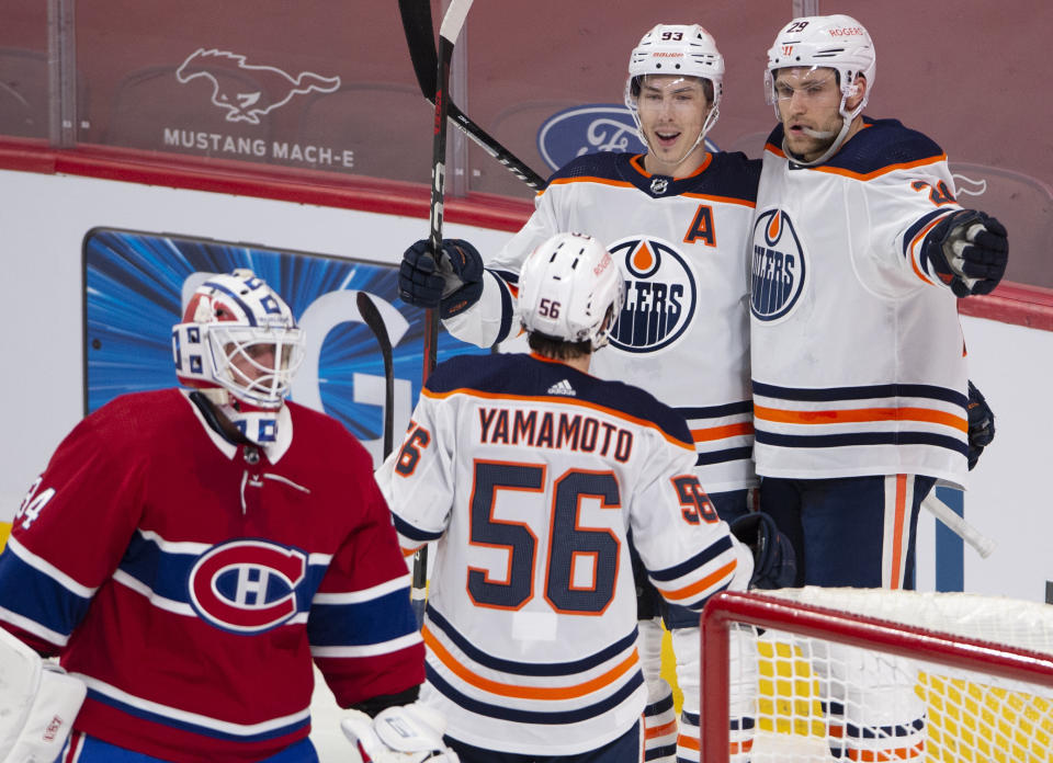 Edmonton Oilers' Ryan Nugent-Hopkins (93) celebrates his goal with teammates Leon Draisaitl (29) and Kailer Yamamoto (56) after scoring the second goal on Montreal Canadiens goaltender Jake Allen (34) during the first period of an NHL hockey game in Montreal, Monday, May 10, 2021. (Ryan Remiorz/The Canadian Press via AP)