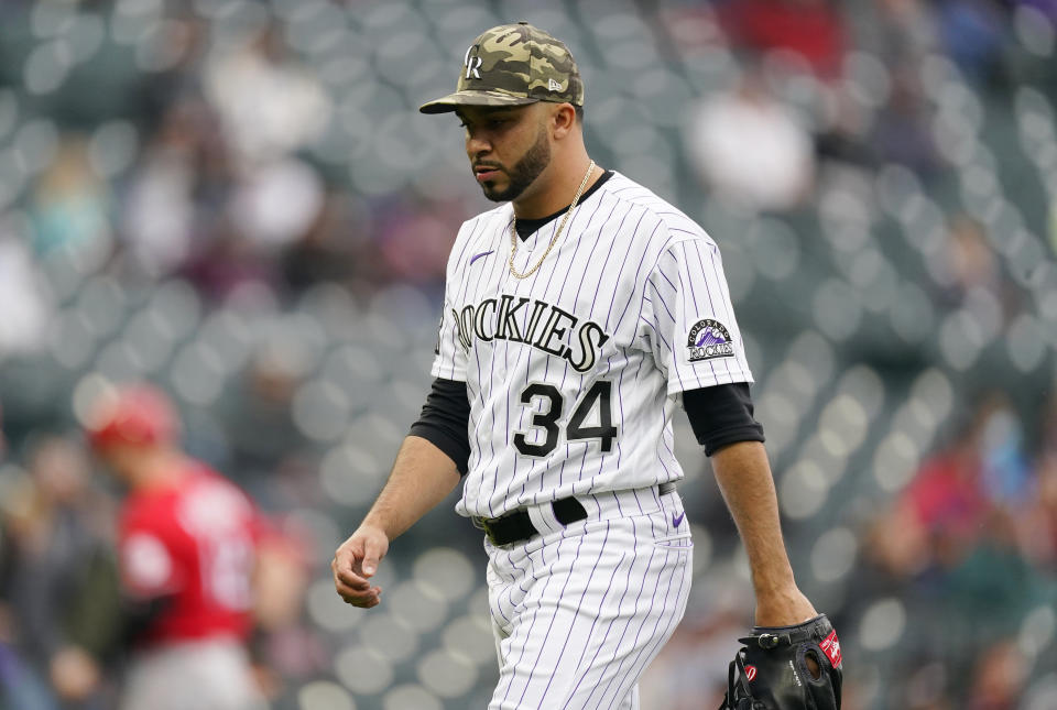 Colorado Rockies relief pitcher Jordan Sheffield heads to the dugout after striking out Cincinnati Reds' Tyler Stephenson to end the top of the ninth inning of a baseball game Sunday, May 16, 2021, in Denver. (AP Photo/David Zalubowski)