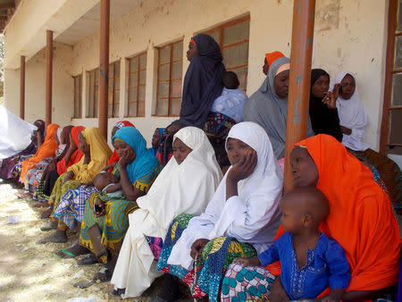 Parents of the missing Dapchi schoolgirls wait for the arrival of Nigeria's President Muhammadu Buhari at the Goverment girls' science and technical college in Dapchi, Nigeria March 14, 2018. REUTERS/Ola Lanre