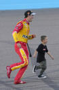 Joey Logano celebrates with his son Hudson after winning a NASCAR Cup Series auto race and championship Sunday, Nov. 6, 2022, in Avondale, Ariz. (AP Photo/Rick Scuteri)