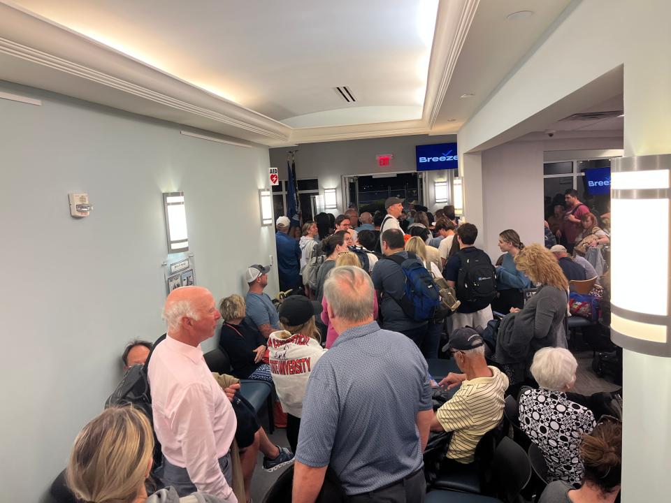 Passengers wait in the Vero Beach Municipal Airport terminal before boarding a Breeze Airways plane on March 18, 2023.