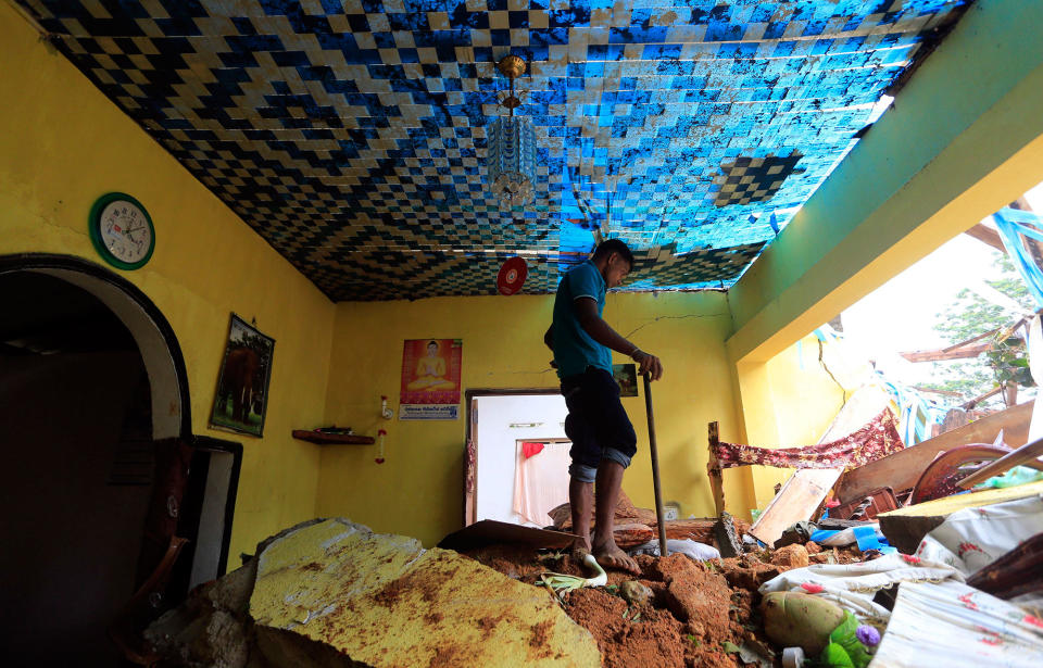 <p>A Sri Lankan mudslide survivor salvages belongings at a destroyed house in Kiribathgala, in Ratnapura district, Sri Lanka, Monday, May 29, 2017. (AP Photo/Eranga Jayawardena) </p>