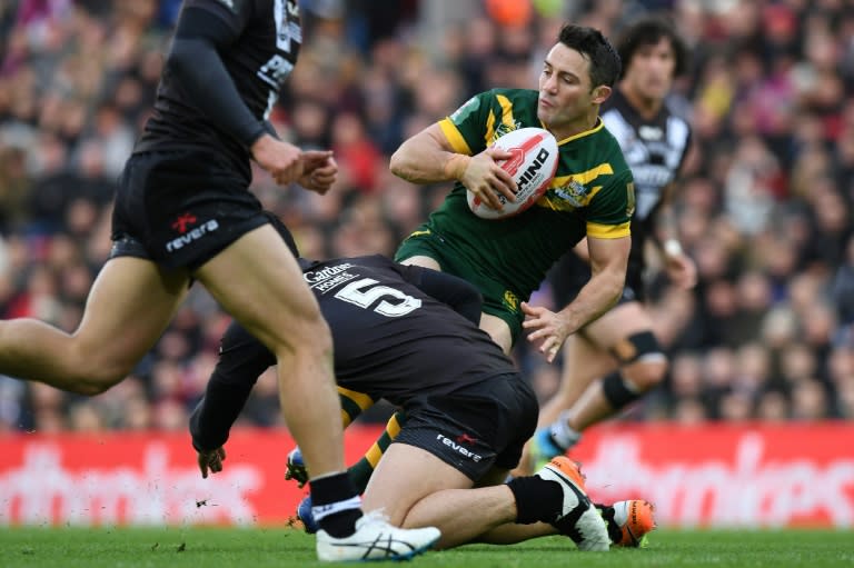 Australia's scrum-half Cooper Cronk (right) is tackled by New Zealand's wing Jordan Rapana during their rugby league Four Nations Final match in Liverpool on November 20, 2016