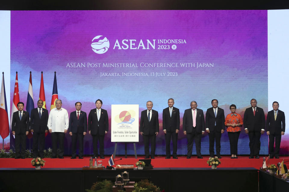 From left to right, Laotian Foreign Minister Saleumxay Kommasith, Malaysian Foreign Minister Zambry Abdul Kadir, Philippine's Foreign Secretary Enrique Manalo, Vietnam's Foreign Minister Bui Thanh Son, Japan's Foreign Minister Yoshimasa Hayashi, Thailand's Foreign Minister Don Pramudwinai, Singapore's Foreign Minister Vivian Balakrishnan, Brunei's Second Minister of Foreign Affair Erywan Yusof, Cambodia's Foreign Minister Prak Sokhonn, Indonesian Foreign Minister Retno Marsudi, East Timor's Foreign Minister Bendito Freitas and ASEAN Secretary General Kao Kim Hourn pose for a group photo with a banner commemorating the 50th anniversary of ASEAN-Japan relations during the ASEAN Post Ministerial Conference with Japan at the Association of Southeast Asian Nations (ASEAN) Foreign Ministers' Meeting in Jakarta, Indonesia, Thursday, July 13, 2023. (Bagus Indahono/Pool Photo via AP)