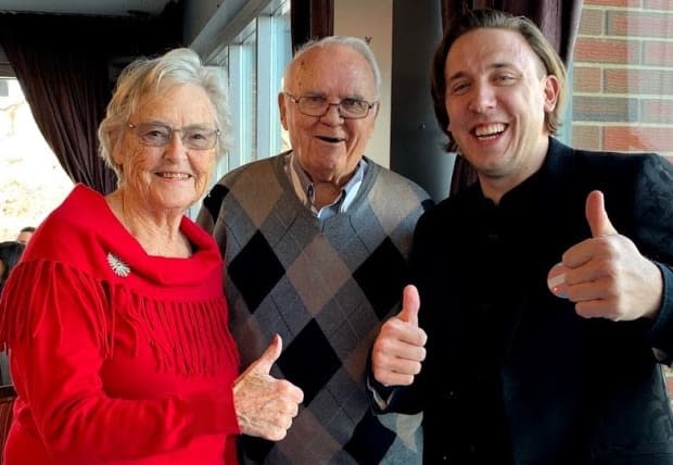 Kory Mathewson, right, with his grandparents Mufty and Bill Mathewson. He helped find a solution to a glitch in Alberta's online booking system for COVID-19 vaccine appointments. (Supplied by Kory Mathewson - image credit)