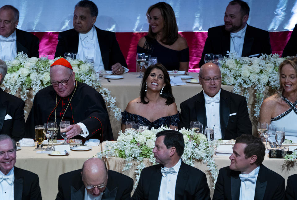 Keynote speaker Ambassador to the United Nations Nikki Haley, center, shares a light moment as she attends the 73rd Annual Alfred E. Smith Memorial Foundation Dinner Thursday, Oct. 18, 2018, in New York. Left is Archbishop of New York Cardinal Timothy Dolan, and right is Michael Haley, husband of Nikki Haley. (AP Photo/Craig Ruttle)