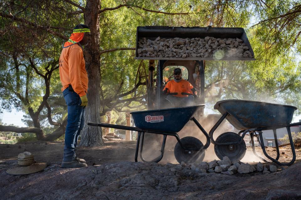 David Hernandez (center) loads rock into a wheelbarrow for a turf conversion/removal project on Sept. 26, 2022, at The Lakes in Las Vegas.