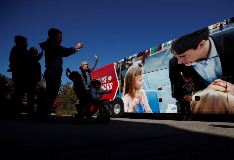 Supporters pose in front of the media bus as Liberal leader and Canadian Prime Minister Justin Trudeau campaigns for the upcoming election in the Hamilton Fire Department in Hamilton