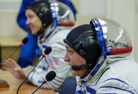 The International Space Station (ISS) crew member Jack Fischer of the U.S. and Fyodor Yurchikhin of Russia (front) talk to their families after space suits check at the Baikonur cosmodrome, Kazakhstan April 20, 2017. REUTERS/Shamil Zhumatov