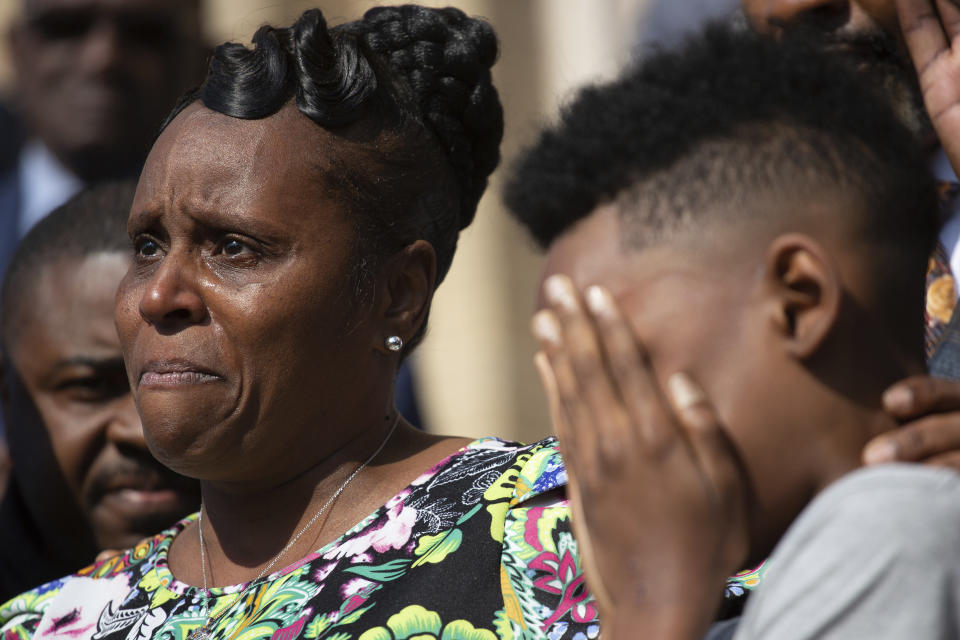 FILE - Tirzah Patterson, former wife of Buffalo shooting victim Heyward Patterson, speaks as her son, Jaques "Jake" Patterson, 12, covers his face during a press conference outside the Antioch Baptist Church on Thursday, May 19, 2022, in Buffalo, N.Y. Tirzah will dedicate this Mother’s Day to the hardest part of a mother’s job, trying to help her child make sense of tragedy. (AP Photo/Joshua Bessex, File)