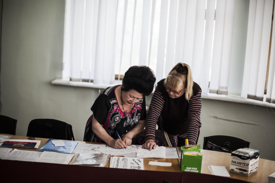 Polling station officials prepare for the upcoming referendum at a polling station in Donetsk, Ukraine, Saturday, May 10, 2014. Two restive regions in eastern Ukraine are preparing to vote on declaring sovereignty and ceding from Ukraine, in a referendum on Sunday in the Donetsk and Luhansk regions, where pro-Russia insurgents have seized government buildings and clashed with police and Ukrainian troops.(AP Photo/Manu Brabo)