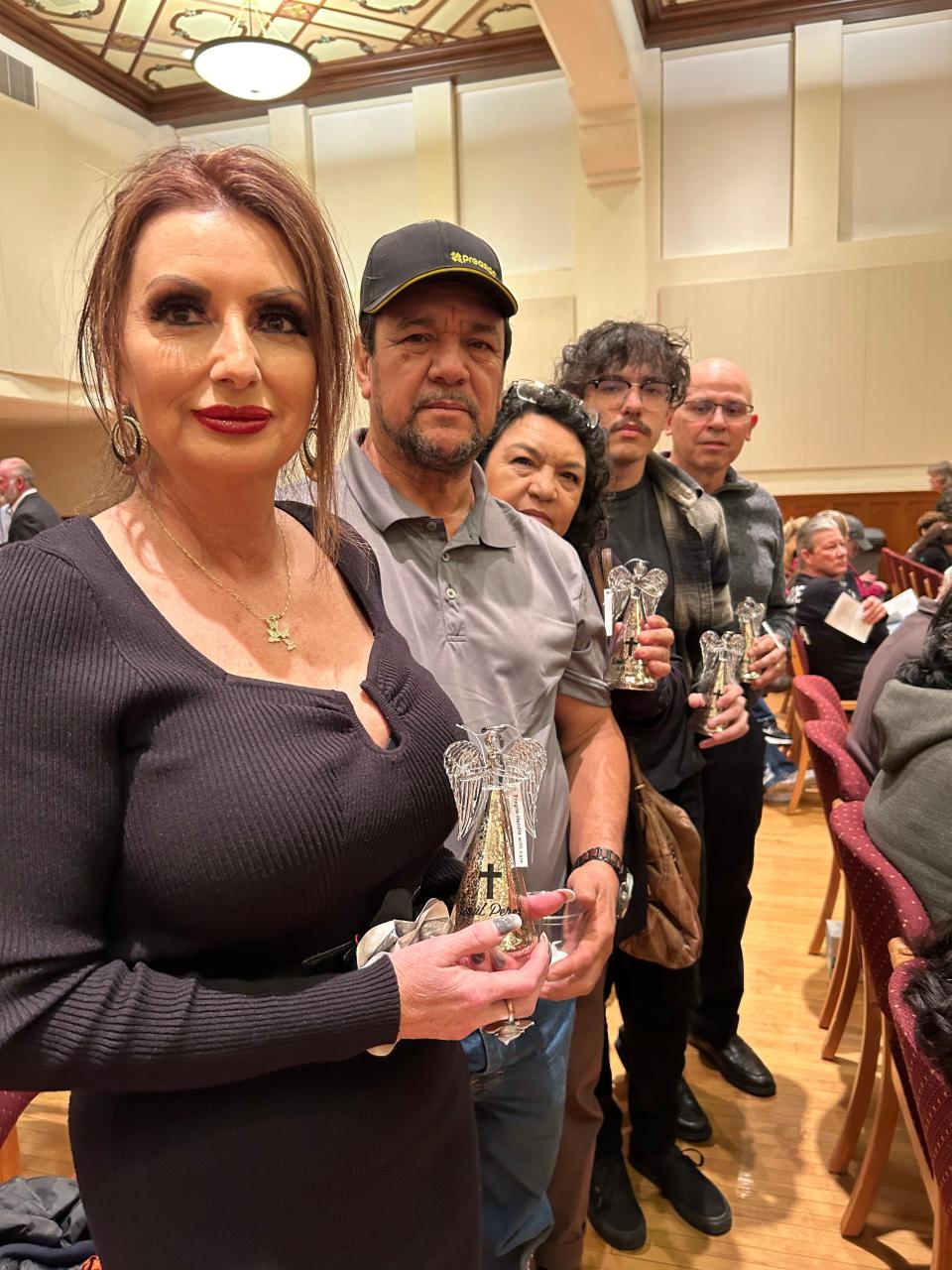 One of the recent victims of violent crimes to attend the Tree of Angels ceremony Friday evening at the Santa Fe Building was Olympia Guirre-Colin, seen standing with her husband and family before the ceremony. Guirre-Colin said it helped her to realize there are others who suffer also. She said she was grateful for the ceremony.