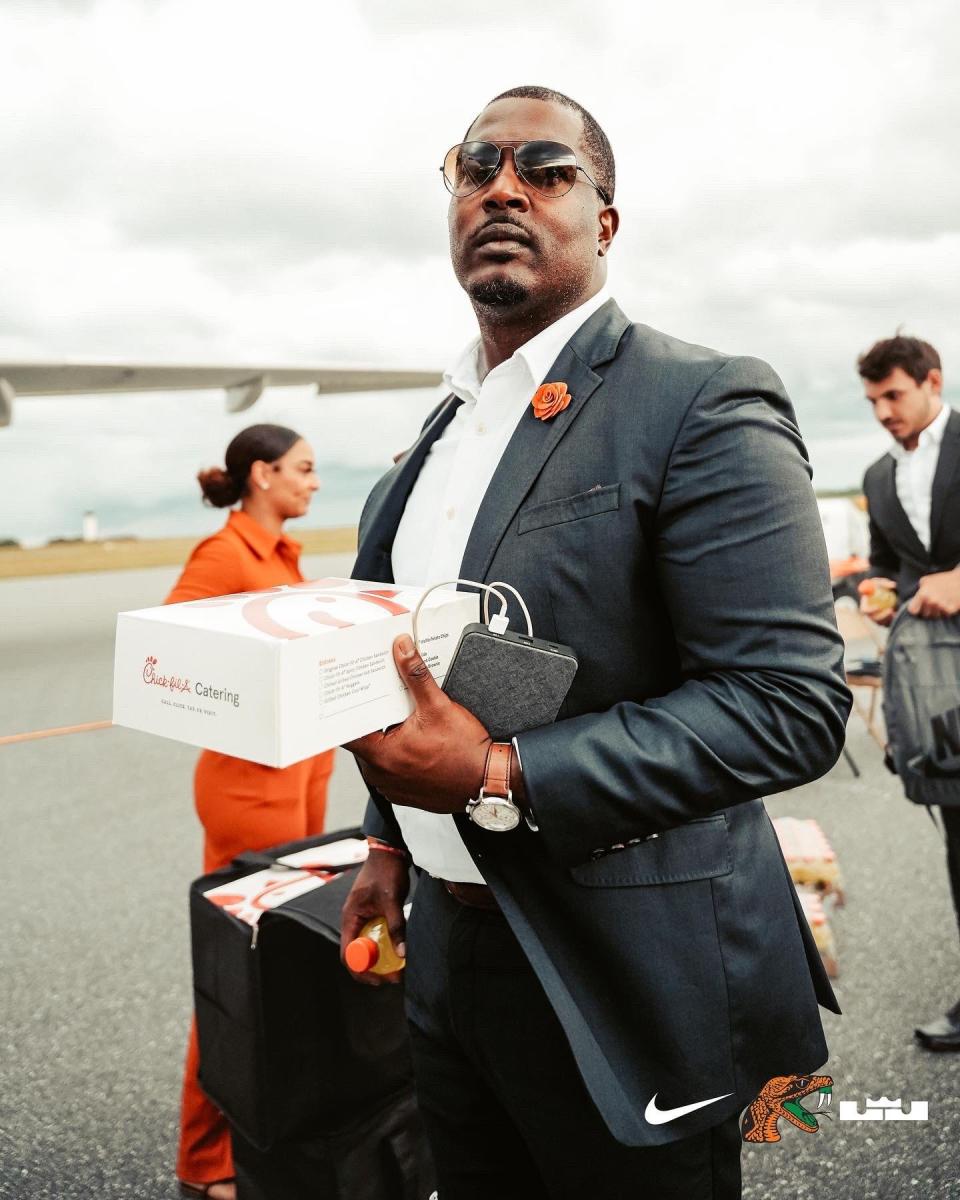 Florida A&M head coach Willie Simmons boards a plane at Tallahassee International Airport to head to the Week 0 game at North Carolina.