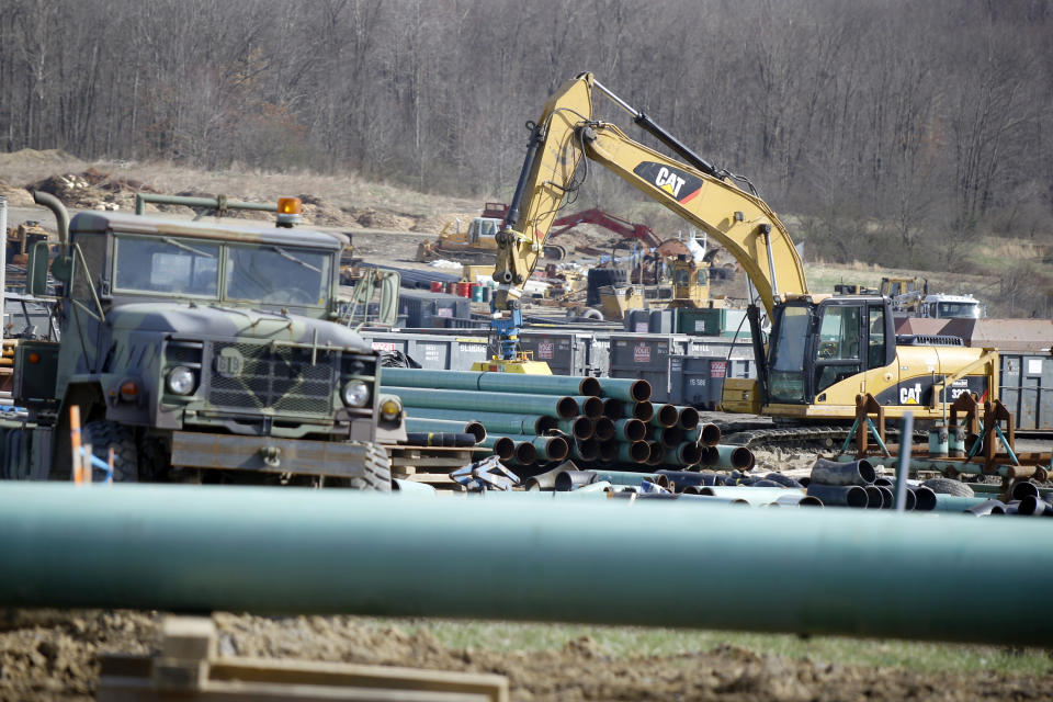 In this Thursday, April 17, 2014 photo, workers continue the construction at a gas pipeline site in Harmony, Pa. Dennis Martire, from the Laborers’ International Union, or LIUNA, said that the man-hours of union work on large pipeline jobs in Pennsylvania and West Virginia have increased by more than 14 times since 2008. (AP Photo/Keith Srakocic)