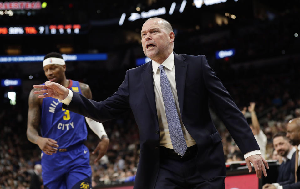 Denver Nuggets head coach Michael Malone argues a call during the first half of Game 4 of an NBA basketball playoff series against San Antonio Spurs in San Antonio, Saturday, April 20, 2019. (AP Photo/Eric Gay)