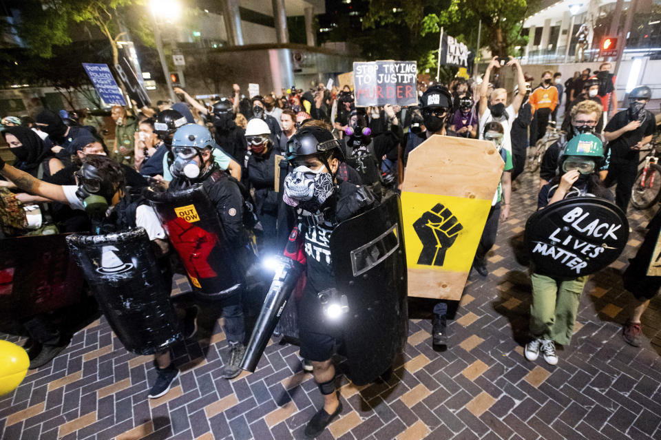 Black Lives Matter protesters march through Portland, Ore. after rallying at the Mark O. Hatfield United States Courthouse on Sunday, Aug. 2, 2020. Following an agreement between Democratic Gov. Kate Brown and the Trump administration to reduce federal officers in the city, nightly protests remained largely peaceful without major confrontations between demonstrators and officers. (AP Photo/Noah Berger)