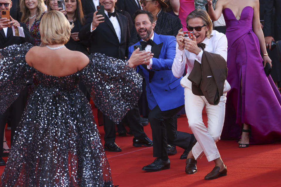 Chris Pine, right, and Nick Kroll, center, take pictures of Florence Pugh upon arrival at the premiere of the film 'Don't Worry Darling' during the 79th edition of the Venice Film Festival in Venice, Italy, Monday, Sept. 5, 2022. (Photo by Joel C Ryan/Invision/AP)