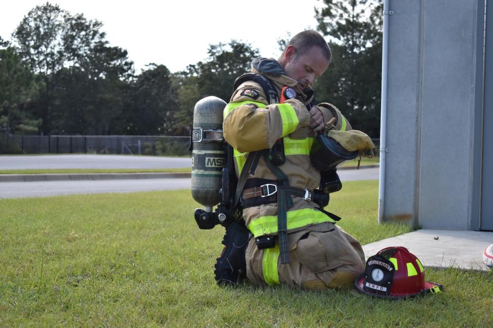 South Walton Fire District Lt. Steve Newsom tightens his gear during a recent training exercise. Newsom returned to work in December 2020 after a months-long battle with cancer.