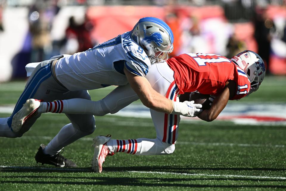 Lions defensive end Aidan Hutchinson takes Patriots wide receiver Tyquan Thornton (11) during the second half Oct. 9, 2022 at Gillette Stadium.