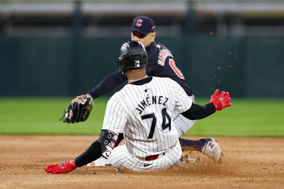 Chicago White Sox's Eloy Jimenez (74) steals second base as Cleveland Guardians second baseman Andres Gimenez (0) reaches to tag him Thursday in Chicago.