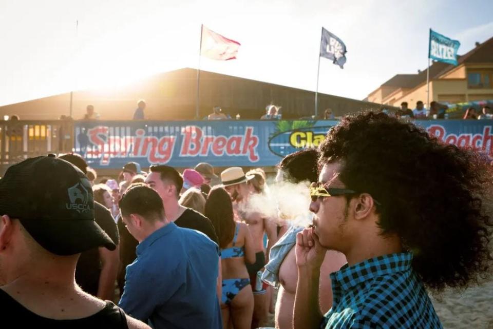 People gathered on the beach in front of Clayton's Beach Bar during spring break on South Padre Island on Wednesday. After Texas college towns initially emerged as coronavirus hot spots during the beginning of the fall semester, university officials are hoping the same won’t occur after the spring break period.