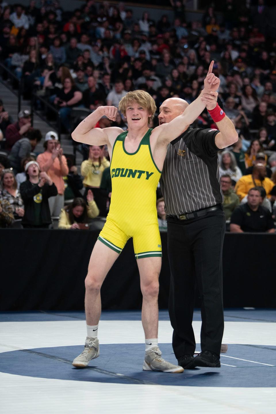 Pueblo County's Boden White has his hand raised as the winner of the 138-pound championship match of the Class 4A state wrestling tournament at Ball Arena on Saturday.