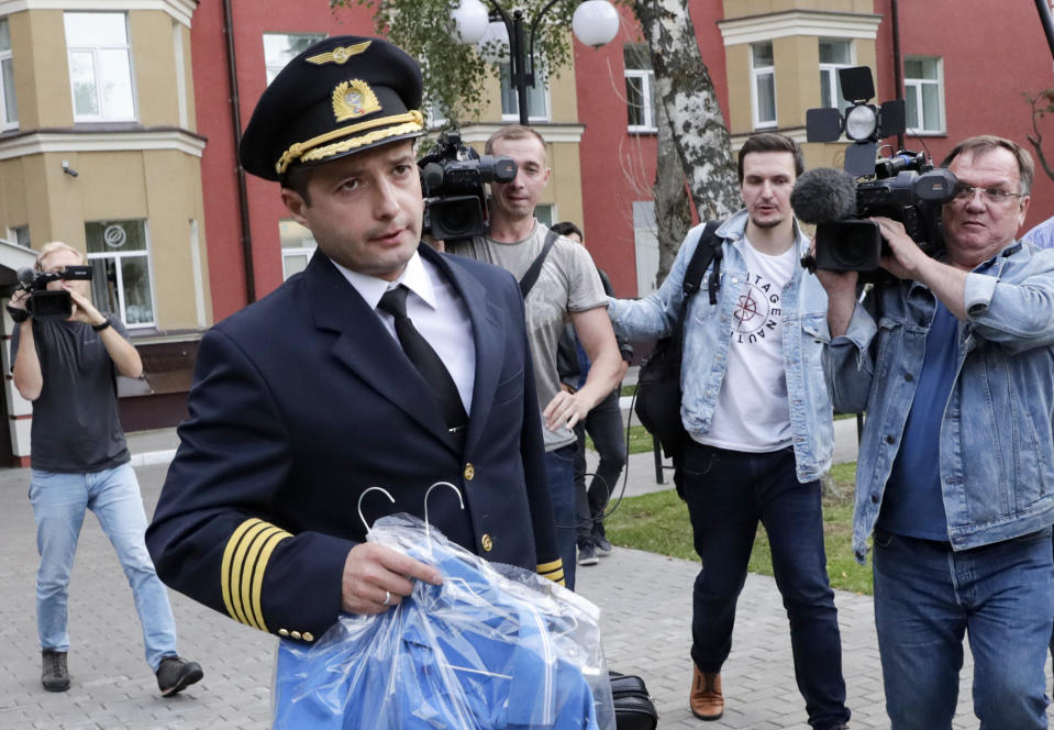 Damir Yusupov, 41, the captain of Ural Airlines A321, walks to attend a news conference in Ramenskoye, just outside Moscow, Russia, Thursday, Aug. 15, 2019.  The captain of a Russian passenger jet was hailed as a hero Thursday for landing his plane in a cornfield after it collided with a flock of gulls seconds after takeoff, causing both engines to malfunction. (AP Photo/Vladimir Shatilov)