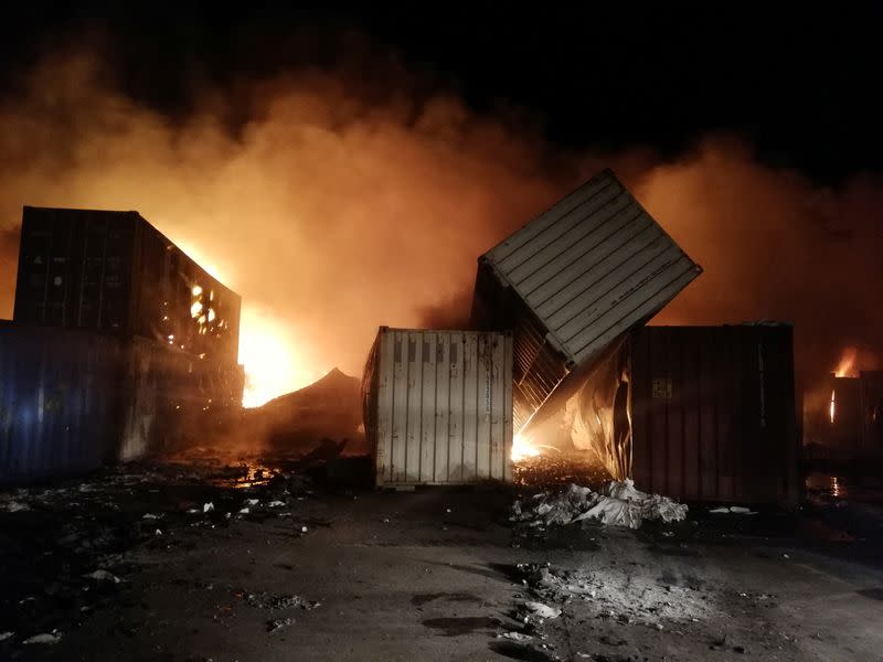 Smoke rises after Syrian state media reported an Israeli missile attack in a container storage area, at Syrian port of Latakia