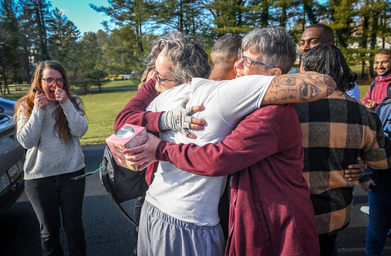 Keith Davis Jr. embraces supporters as he arrives at a gathering following his released from custody Friday, Jan. 13, 2023, in Baltimore, after prosecutors dropped all charges against him. Davis was tried for the same murder four times and was awaiting a potential fifth trial when newly elected State's Attorney Ivan Bates announced his decision to dismiss the case. (Jerry Jackson/The Baltimore Sun via AP) ORG XMIT: MDBAE202