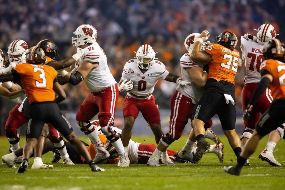 Dec 27, 2022; Phoenix, Arizona, USA; Wisconsin Badgers running back Braelon Allen (0) runs the ball against the Oklahoma State Cowboys in the first half of the 2022 Guaranteed Rate Bowl at Chase Field. Mandatory Credit: Mark J. Rebilas-USA TODAY Sports Mark J. Rebilas/Mark J. Rebilas-USA TODAY Sports