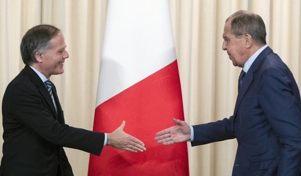 Russian Foreign Minister Sergey Lavrov, right, and Italian Foreign Minister Enzo Moavero Milanesi shake hands during their meeting in Moscow, Russia, Monday, Oct. 8, 2018. (AP Photo/Pavel Golovkin)