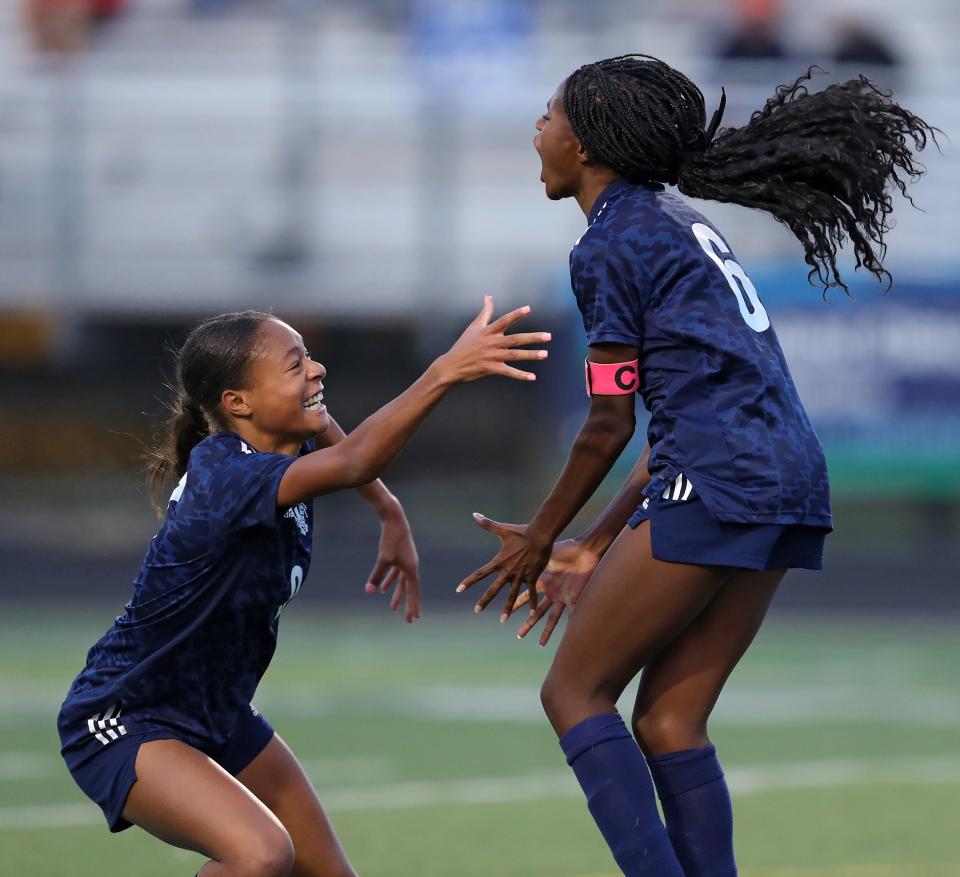 Twinsburg's Arriah Gilmer, left, congratulates Jadyn Harris after scoring a goal during the first half of a Division I district semifinal soccer game against the Stow Bulldogs, Monday, Oct. 24, 2022, in Twinsburg, Ohio.