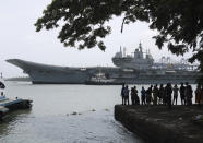 People watch the INS Vikrant leave for trials in the Arabian Sea in Kochi, India, July 2, 2022. India is preparing to relaunch INS Vikramaditya aircraft carrier after a major refit, a critical step toward fulfilling its plan to deploy two carrier battle groups as it seeks to strengthen its regional maritime power to counter China's increasing assertiveness. (AP Photo/Melton Antony)