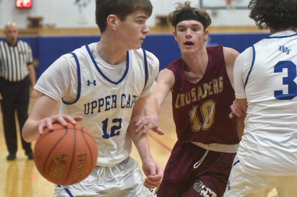 Upper Cape Tech's Matt Nawoichick looks for a way around Cape Tech's Josh Wiggins in this Jan. 21 game action.