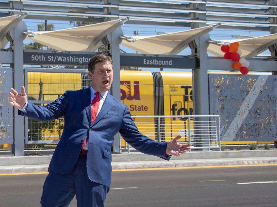 In an April 2019 photo, U.S. Rep. Greg Stanton cheers as the light rail train arrives at the new 50th and Washington streets station.