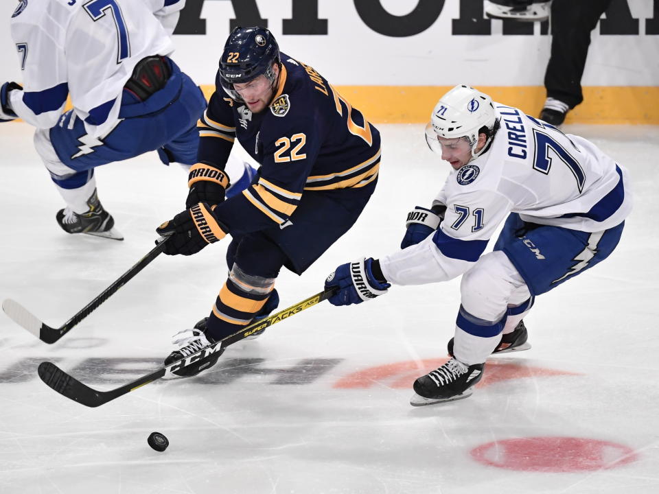 Buffalo Sabres' Johan Larsson (22) and Tampa' Bay Lightning Anthony Cirelli (71) go after the puck during an NHL hockey game in Globen Arena, Stockholm Sweden. Friday. Nov. 8, 2019. (Anders Wiklund/TT via AP)