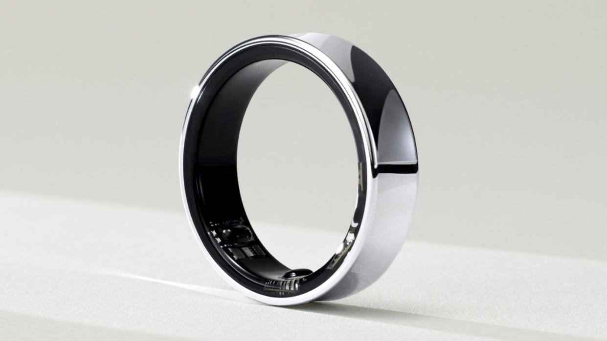  The Samsung Galaxy Ring sitting on a pale surface. 