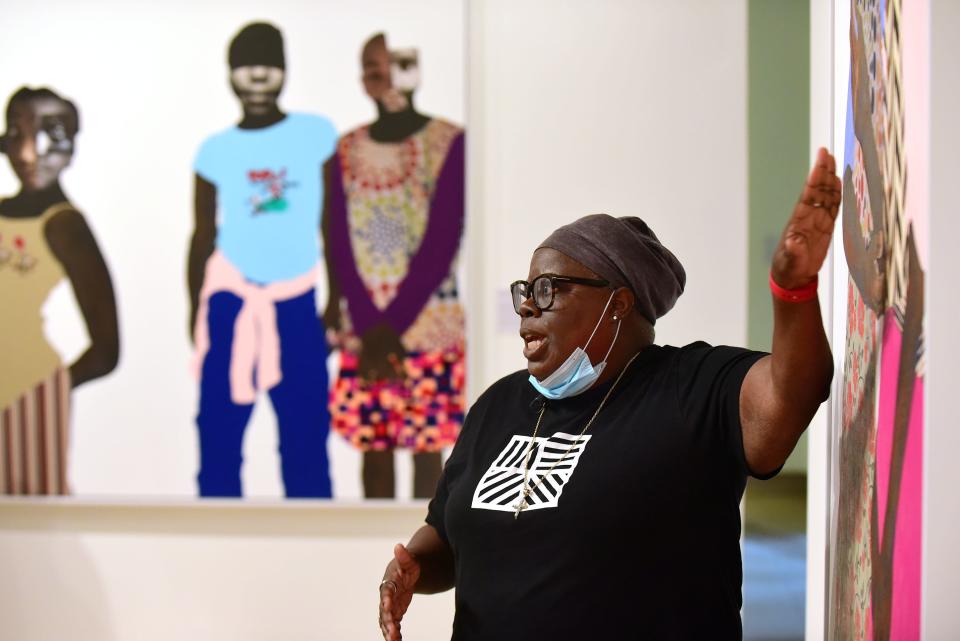 Artist Deborah Roberts answers questions about her work during a tour of her exhibit "Deborah Roberts: I'm".