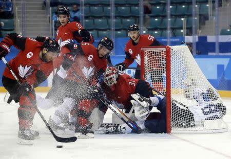 Ice Hockey - Pyeongchang 2018 Winter Olympics - Man’s Quarterfinal Match - Canada v Finland - Gangneung Hockey Centre, Gangneung, South Korea - February 21, 2018 - Veli-Matti Savinainen of Finland crashes into the net. REUTERS/David W Cerny