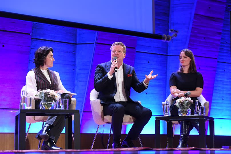 Joseph McGinty Nichol speaking on stage at a UNESCO conference on AI in Paris, 19 October 2023.