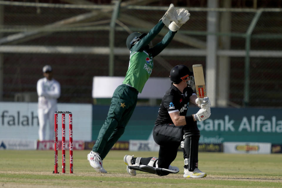 Pakistan's Mohammad Rizwan, center back, takes the catch of New Zealand's Henry Nicholls, right, during the fifth one-day international cricket match between New Zealand and Pakistan, in Karachi, Pakistan, Sunday, May 7, 2023. (AP Photo/Fareed Khan)