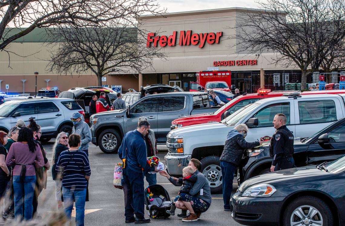 Police talk with employees and customers who were inside the Richland Fred Meyer when Instacart shopper Justin Krumbah was shot and killed.