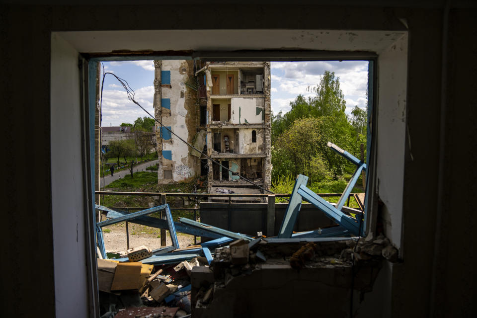 A person walks next to partially destroyed buildings in Russian attacks in Borodyanka, north of Kyiv, Ukraine, Saturday, April 27, 2024. Borodyanka was occupied by Russian troops at the beginning of their full-scale invasion in 2022. (AP Photo/Francisco Seco)